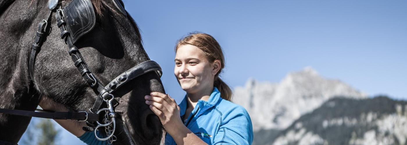 Schülerin der LLA Weitau streichelt ein Pferd